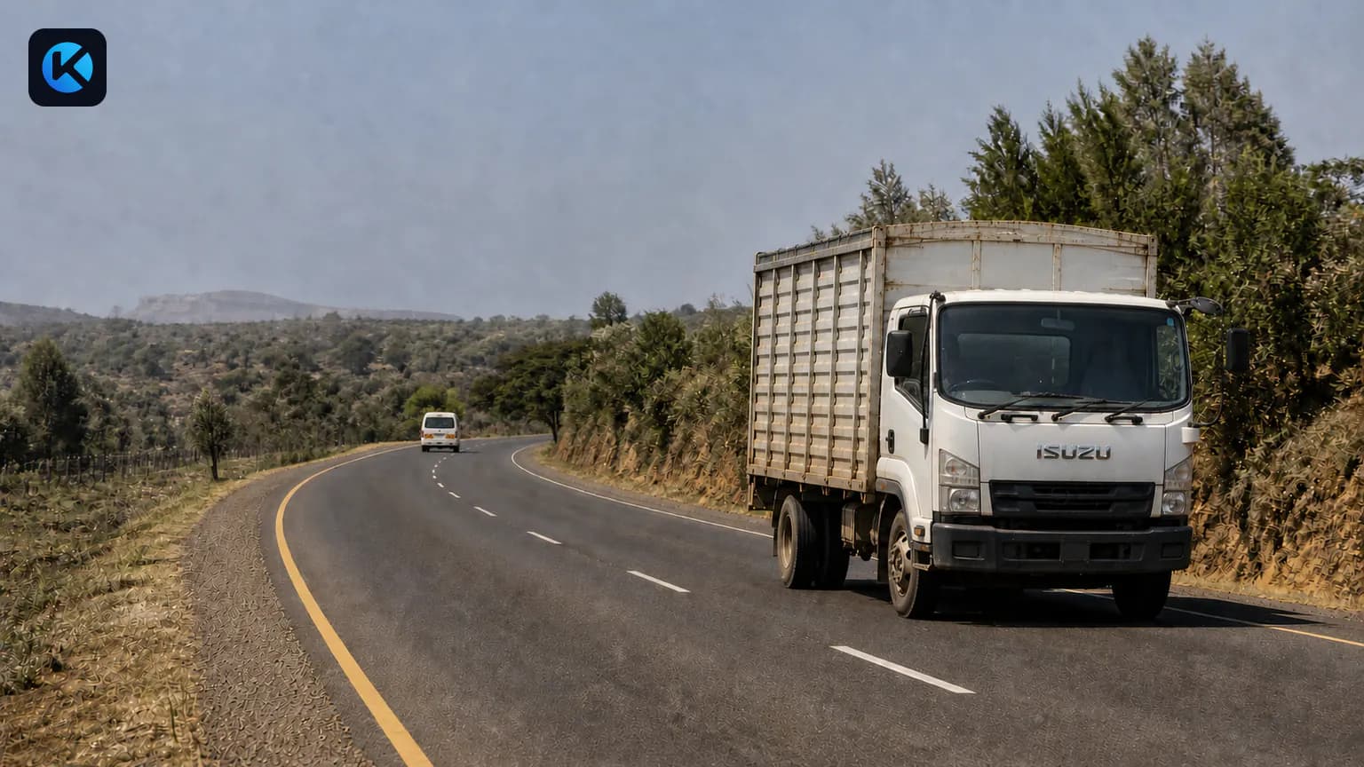 Isuzu cargo lorry with a matatu in the distance on a Kenyan highway
