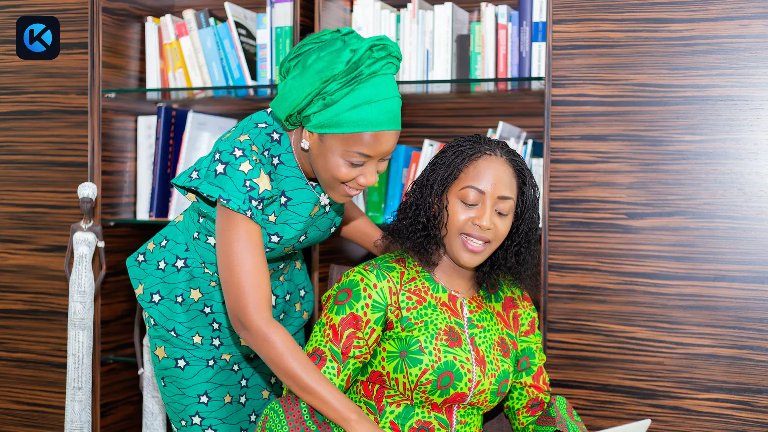 Two African professionals reviewing information together on a laptop